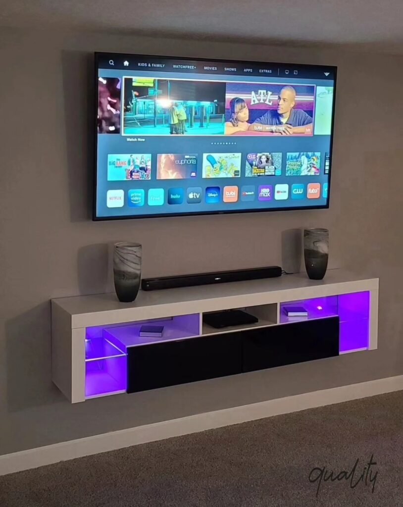 Wall-mounted TV with soundbar and illuminated floating console in a real customer project