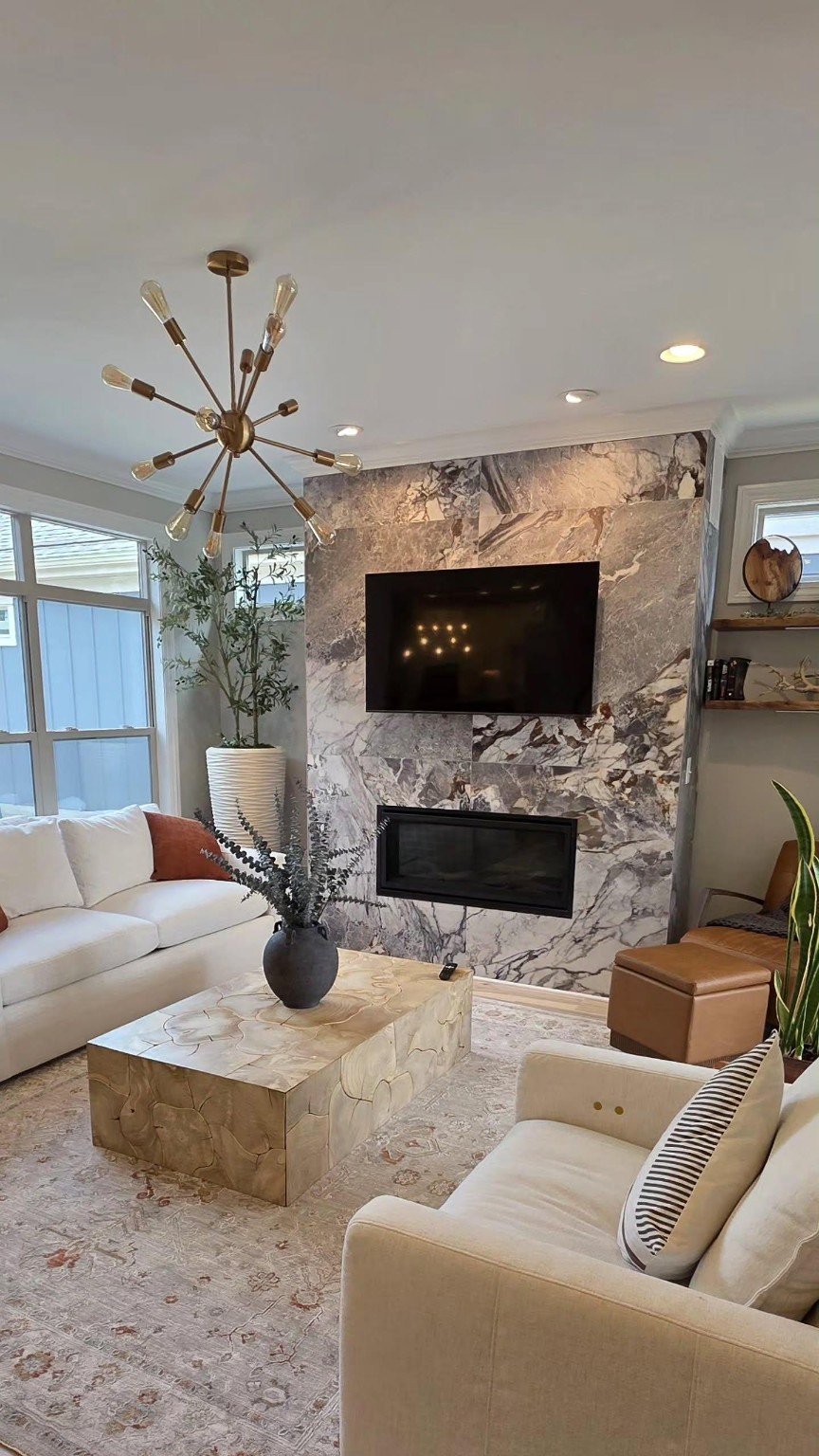 TV mounted on an existing marble fireplace wall in a furnished living room